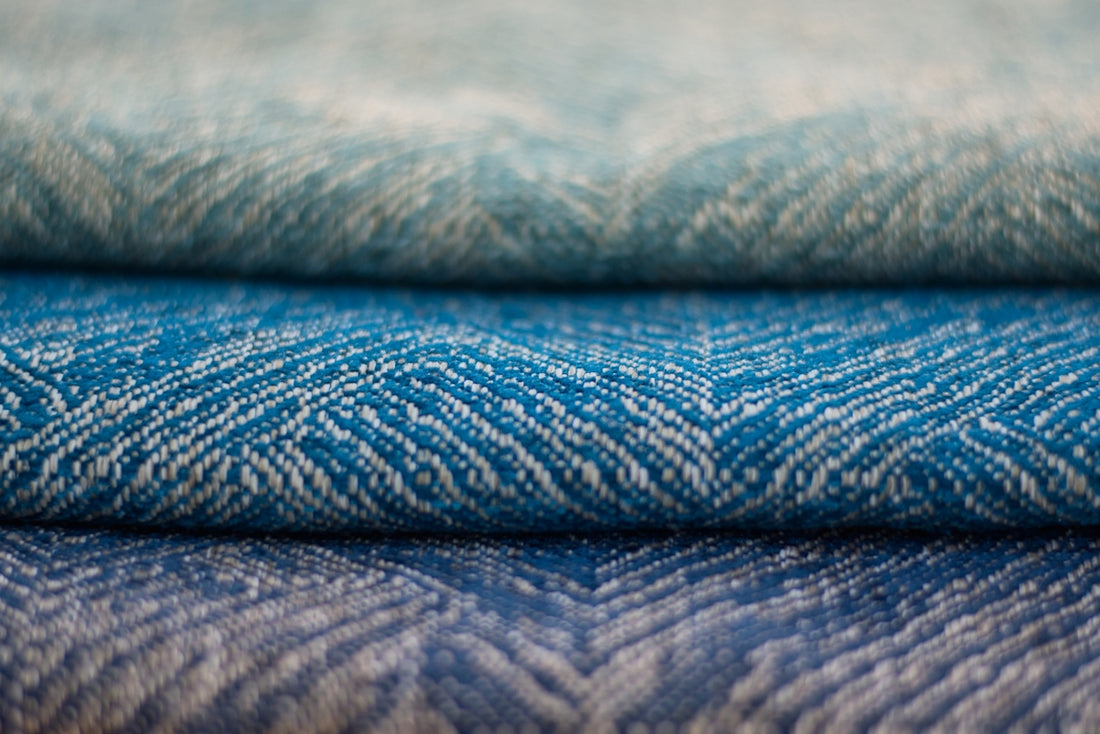 a close up of three different colored fabrics