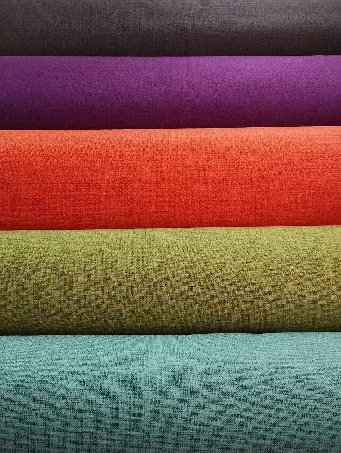 a stack of different colors of fabric