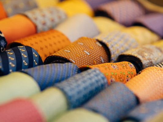 a close up of many different colored ties